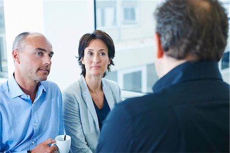 Businesspeople chatting in office Stock Photo - Premium Royalty-Free, Code: 649-07710481