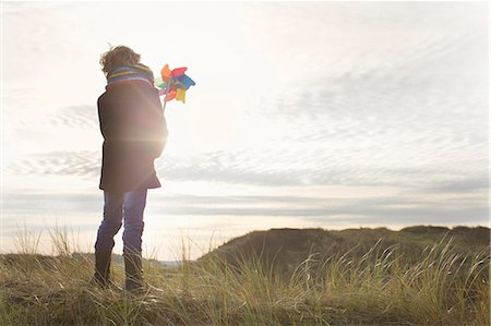 simsearch:649-08894169,k - Rear view of boy holding up paper windmill at coast Stock Photo - Premium Royalty-Free, Code: 649-07710754