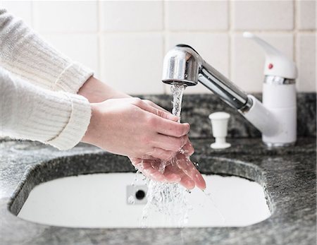 simsearch:649-08144531,k - Cropped shot of young woman washing hands in sink Stock Photo - Premium Royalty-Free, Code: 649-07736434