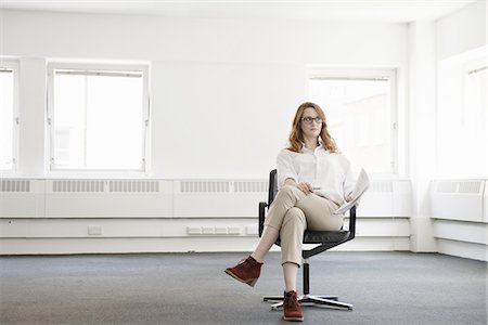 empty - Mid adult businesswoman on office chair in new office Stock Photo - Premium Royalty-Free, Code: 649-07736451