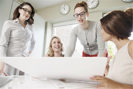 Four businesswomen looking at blueprint in office Stock Photo - Premium Royalty-Free, Code: 649-07736460