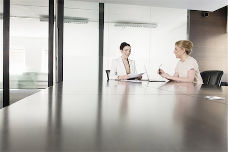 surface level - Two young businesswomen meeting in boardroom Stock Photo - Premium Royalty-Free, Code: 649-07736478