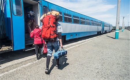 Rear view of young hikers with backpacks boarding a train Stock Photo - Premium Royalty-Free, Code: 649-07736641