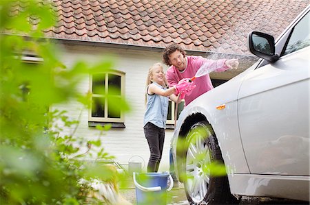 family house outside - Girl helping father wash his car Stock Photo - Premium Royalty-Free, Code: 649-07736711