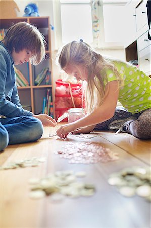 Brother and sister counting coins from savings jar Stock Photo - Premium Royalty-Free, Code: 649-07736736