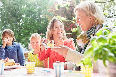 summer party adults - Mother serving birthday cake to family at birthday party Stock Photo - Premium Royalty-Free, Code: 649-07736733