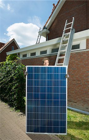 people carrying the ladder - Portrait of male with solar panel for roof of new home, Netherlands Stock Photo - Premium Royalty-Free, Code: 649-07736924