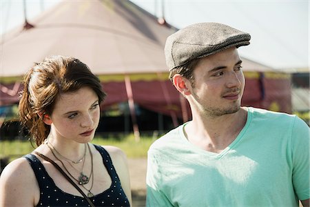 person staring - Young couple staring and distracted at funfair Stock Photo - Premium Royalty-Free, Code: 649-07736942