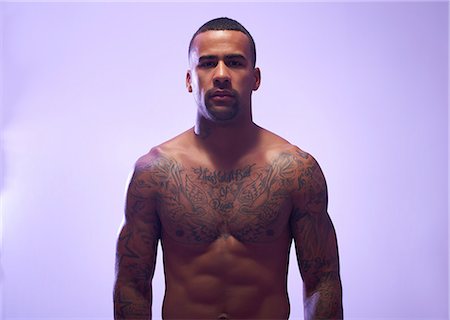 simsearch:649-07737112,k - Studio portrait of muscular sportsman with bare chest and tattoos Stockbilder - Premium RF Lizenzfrei, Bildnummer: 649-07737111