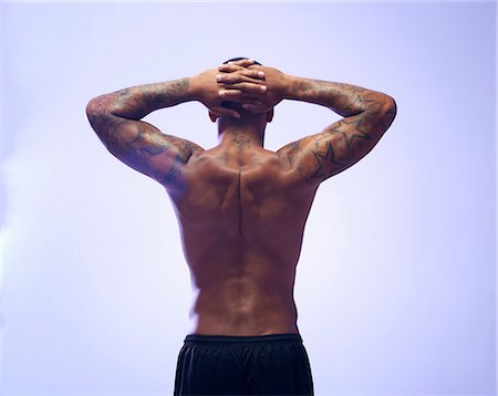 simsearch:649-07737112,k - Rear view studio shot of muscular young sportsman with hands behind head Stockbilder - Premium RF Lizenzfrei, Bildnummer: 649-07737112