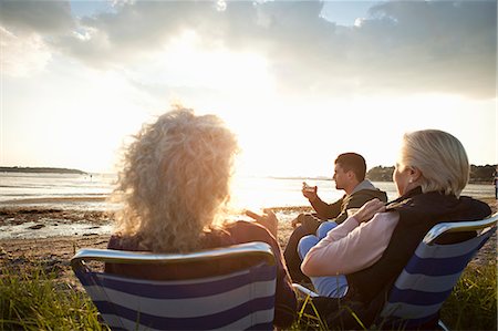 daughter and senior from behind - Family members relaxing by beach Stock Photo - Premium Royalty-Free, Code: 649-07760805