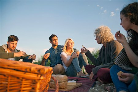 ethnic picnic - Five adult friends having picnic on Bournemouth beach, Dorset, UK Stock Photo - Premium Royalty-Free, Code: 649-07760813