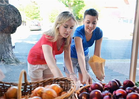 Two young women choosing food at market stall Stock Photo - Premium Royalty-Free, Code: 649-07760845