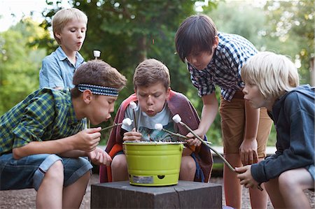 Group of young boys toasting marshmallows over bucket barbecue Stock Photo - Premium Royalty-Free, Code: 649-07760871