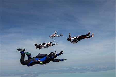 Four young adult male skydivers free falling, Siofok, Somogy, Hungary Stock Photo - Premium Royalty-Free, Code: 649-07760931