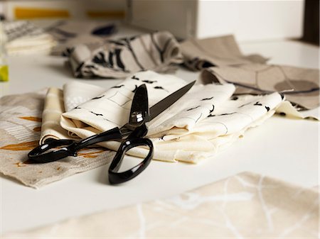 processing - Pair of scissors and fabric on work table Stock Photo - Premium Royalty-Free, Code: 649-07760964