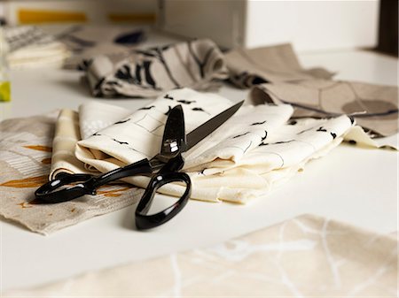 design on fabric - Pair of scissors and fabric on work table Stock Photo - Premium Royalty-Free, Code: 649-07760964