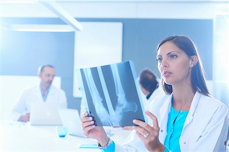 discussion group photo - Female doctor looking at x-ray Stock Photo - Premium Royalty-Free, Code: 649-07761041