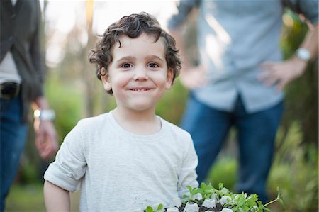 egg box - Portrait of boy with plants in egg carton in allotment Stock Photo - Premium Royalty-Free, Code: 649-07761193