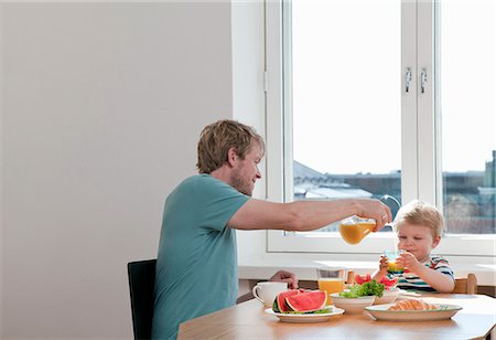 dad in kitchen - Father and toddler son having breakfast at kitchen table Stock Photo - Premium Royalty-Free, Code: 649-07761253