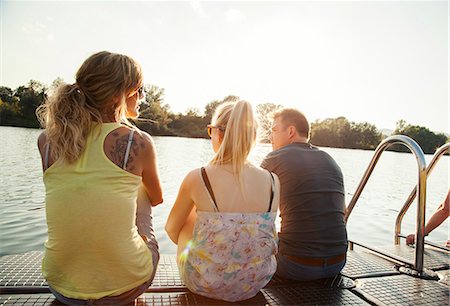 simsearch:649-08125388,k - Three young adult friends gazing from riverside pier Stock Photo - Premium Royalty-Free, Code: 649-07804001
