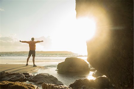 Mature man exercising on beach, looking out to sea Stock Photo - Premium Royalty-Free, Code: 649-07804070