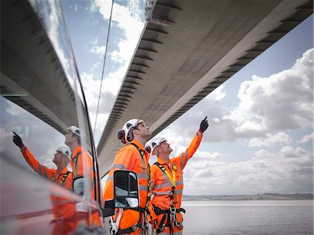 Bridge workers and support truck under suspension bridge. The Humber Bridge, UK was built in 1981 and at the time was the world's largest single-span suspension bridge Stock Photo - Premium Royalty-Free, Code: 649-07804212