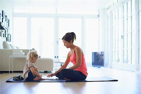 simsearch:6113-07543284,k - Mid adult mother and toddler daughter practicing yoga in living room Stock Photo - Premium Royalty-Free, Code: 649-07804309