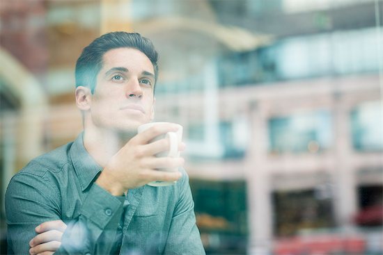 Young businessman drinking coffee and looking out of cafe window, London, UK Stock Photo - Premium Royalty-Free, Image code: 649-07804319