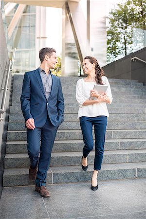 people walking in the london - Rear view of young businessman and woman walking down stairway, London, UK Stock Photo - Premium Royalty-Free, Code: 649-07804323