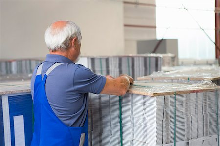 simsearch:649-07804440,k - Factory worker moving and stacking cardboard Stock Photo - Premium Royalty-Free, Code: 649-07804465