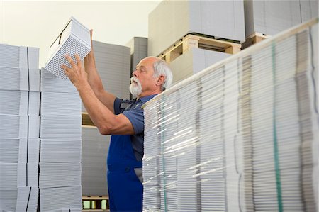 simsearch:649-07804440,k - Factory worker moving and stacking cardboard Stock Photo - Premium Royalty-Free, Code: 649-07804462