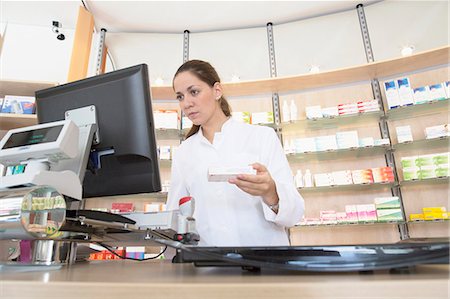 shelf - Pharmacist in pharmacy using computer Photographie de stock - Premium Libres de Droits, Code: 649-07804631