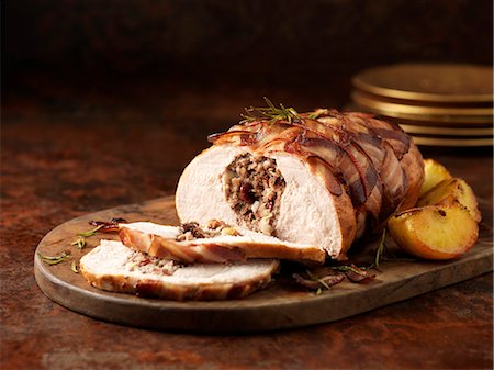 dinner table christmas - Christmas dinner. Turkey breast with pork, apple & cranberry stuffing and rosemary Stock Photo - Premium Royalty-Free, Code: 649-07804851