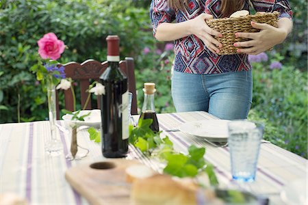 Woman setting the table outdoors Stock Photo - Premium Royalty-Free, Code: 649-07804908