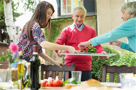 people carrying lunch - Young woman with grandparents setting the table Stock Photo - Premium Royalty-Free, Code: 649-07804911