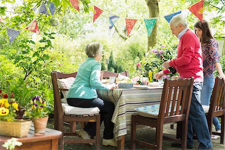 patio furniture - Family sitting down for an outdoor meal Stock Photo - Premium Royalty-Free, Code: 649-07804912