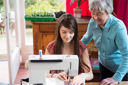 sewing top view - Senior woman watching granddaughter use sewing machine Stock Photo - Premium Royalty-Free, Code: 649-07804924