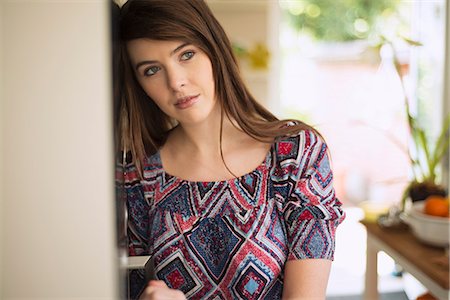 person in front of a door - Young brunette woman, portrait Stock Photo - Premium Royalty-Free, Code: 649-07804920