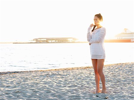 simsearch:649-06844679,k - Young woman looking away on sunlit beach, Port Melbourne, Melbourne, Victoria, Australia Stock Photo - Premium Royalty-Free, Code: 649-07804943