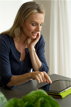 person touch screen - Mature woman using digital tablet Stock Photo - Premium Royalty-Free, Code: 649-07804997