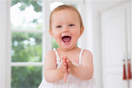 people with open mouth - Baby girl clapping hands, portrait Stock Photo - Premium Royalty-Free, Code: 649-07805136