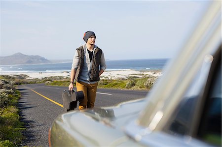 south africa and musician - Young man behind parked car with guitar case, Cape Town, Western Cape, South Africa Stock Photo - Premium Royalty-Free, Code: 649-07803260