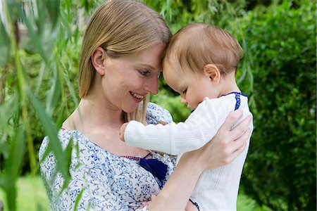 simsearch:614-08030653,k - Mother and baby daughter face to face in garden Stock Photo - Premium Royalty-Free, Code: 649-07803422