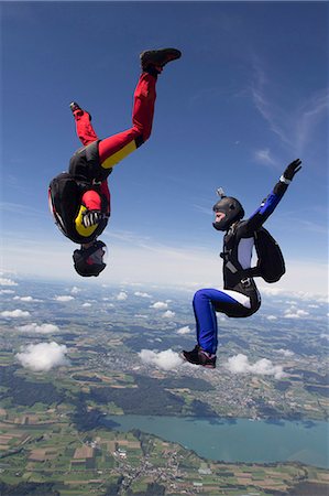 skydiving woman - Team of two female skydivers in sit fly and head down positions over Buttwil, Luzern, Switzerland Stock Photo - Premium Royalty-Free, Code: 649-07803765