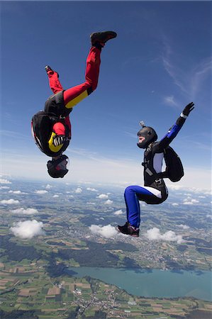 skydiver - Team of two female skydivers in sit fly and head down positions over Buttwil, Luzern, Switzerland Stock Photo - Premium Royalty-Free, Code: 649-07803765