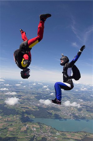 simsearch:649-09206796,k - Team of two female skydivers in sit fly and head down positions over Buttwil, Luzern, Switzerland Stock Photo - Premium Royalty-Free, Code: 649-07803765