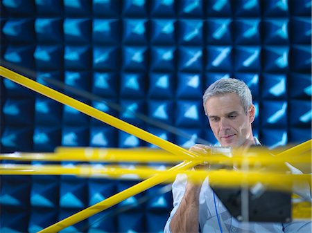 Scientist preparing to measure electromagnetic waves in anechoic chamber, close up Stock Photo - Premium Royalty-Free, Code: 649-07803830