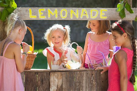 selling - Candid portrait of four girls at lemonade stand in park Stock Photo - Premium Royalty-Free, Code: 649-07803973