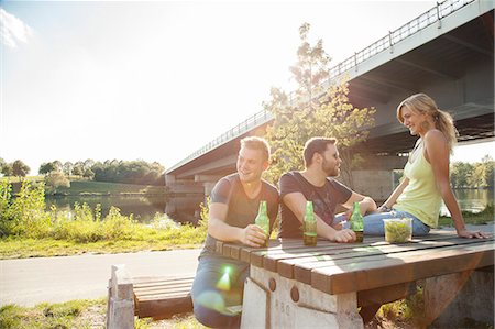 picnic table - Three young friends drinking beer on riverside picnic bench Stock Photo - Premium Royalty-Free, Code: 649-07803997